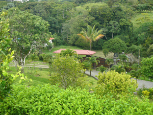 From the rancho mesita, one can look down to the roofed gate beside the road to the village of El Roble.